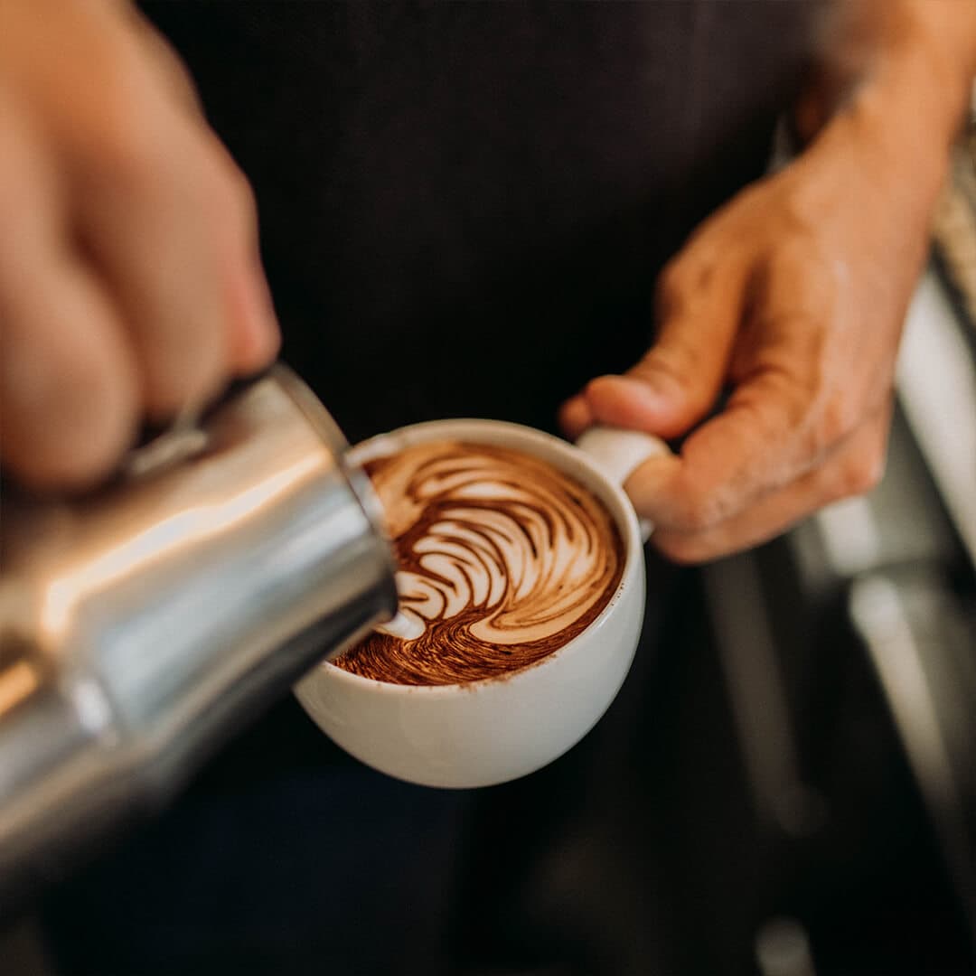 coffee being poured into a mug